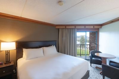 King Room at Lake Placid Club Grandview with a simple table and chairs by sliding glass doors leading to a private balcony