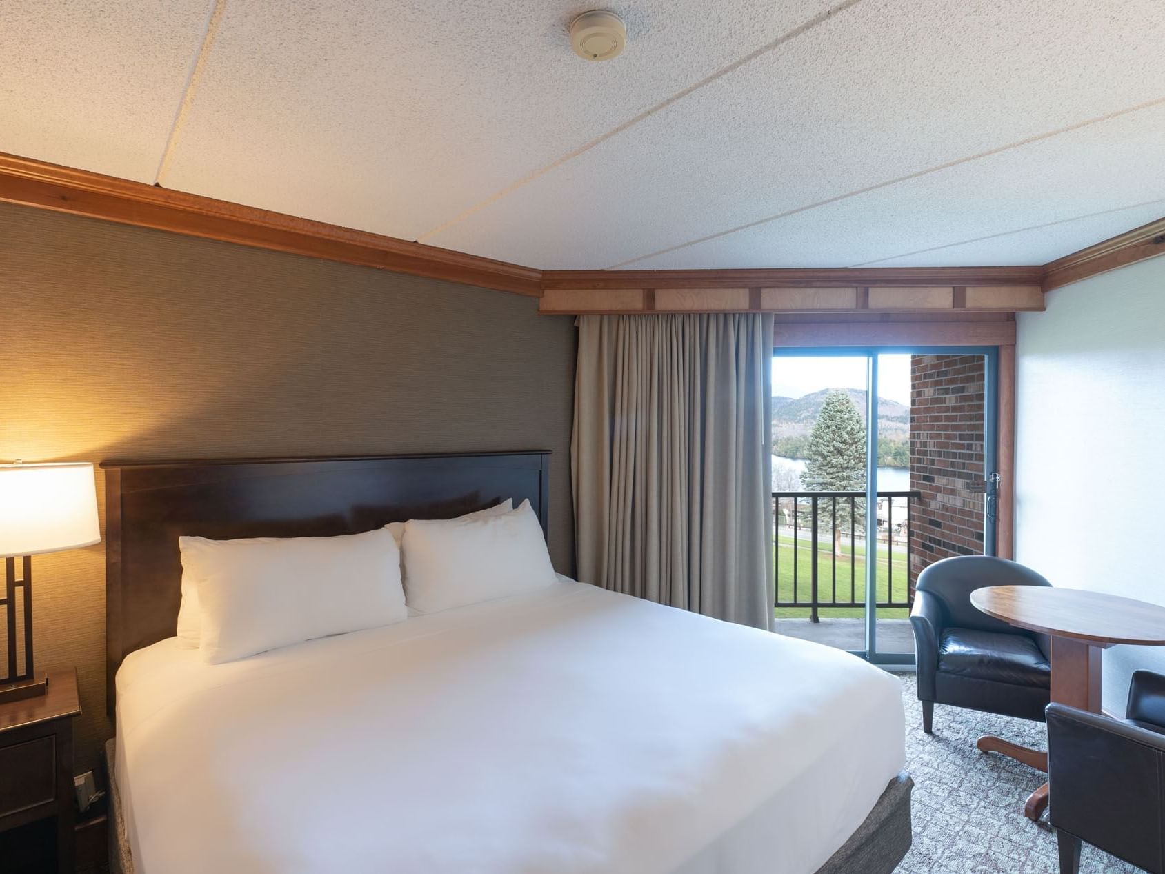 King Room featuring a comfortable king bed and a balcony with a view at Lake Placid Club Grandview