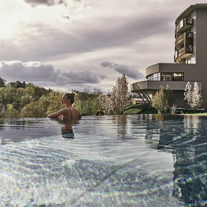 Lady in a pool by the hotel at Falkensteiner Balance Resort Stegersbach