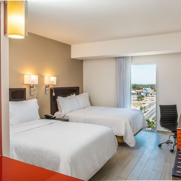 Twin beds with working desk in Superior Room at Fiesta Inn
