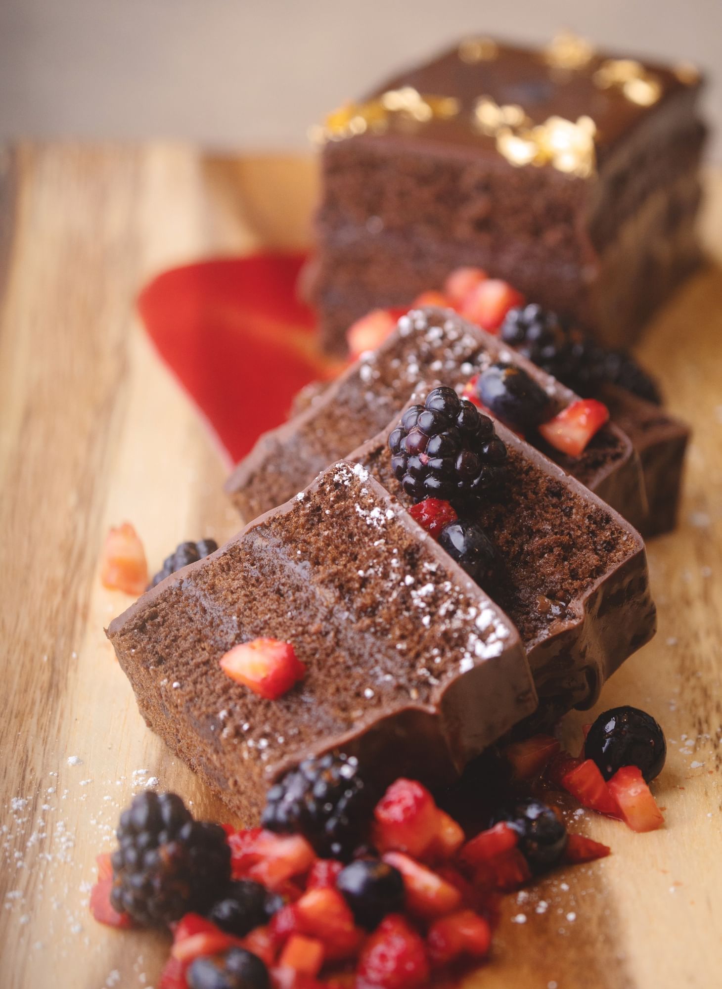 Lorem ipsum Sliced up chocolate cake dessert with diced strawberries, blueberries and black berries