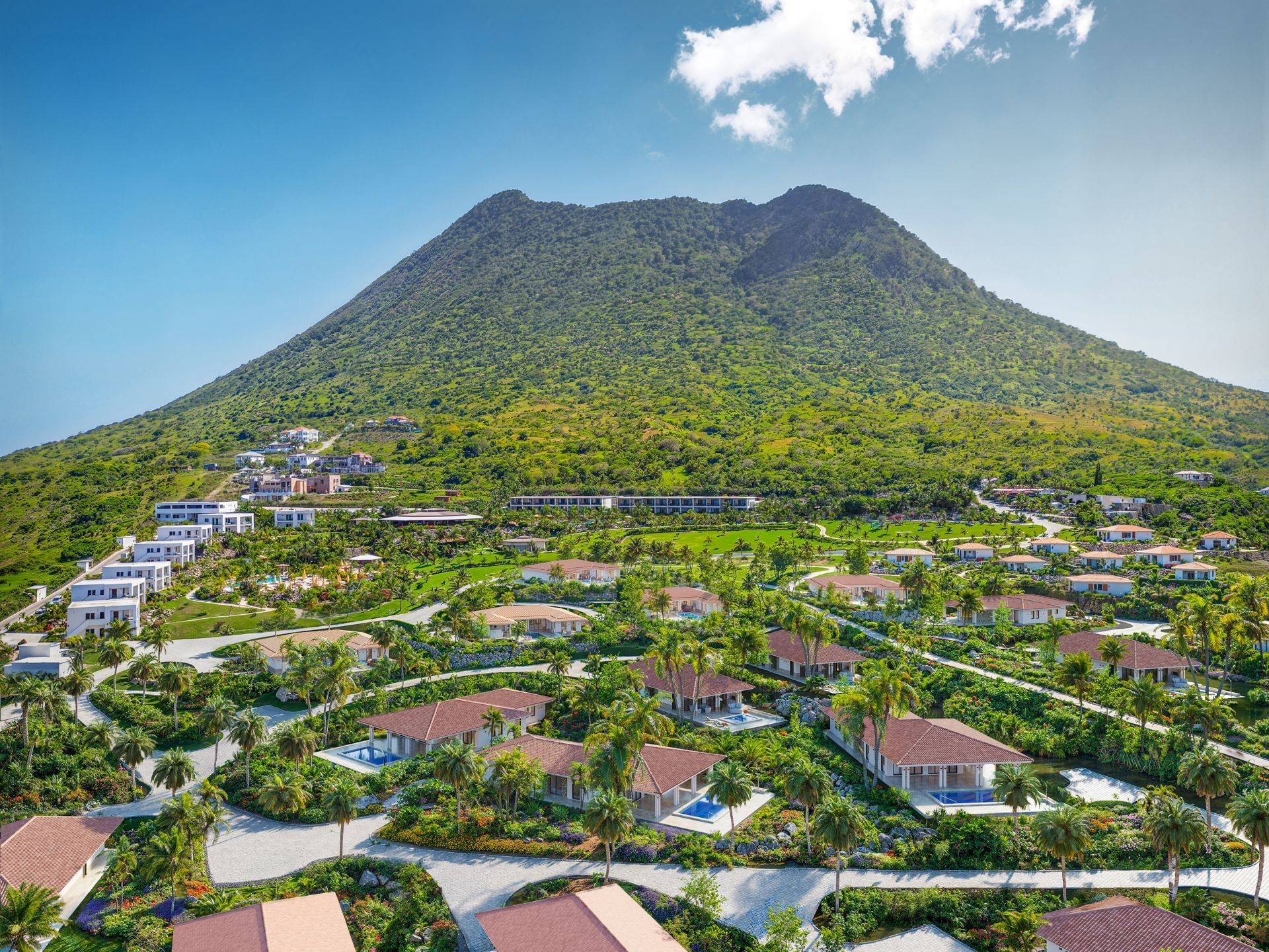 Aerial view of luxury villas surrounded by lush tropical gardens near Mount Mazinga peak at Golden Rock Resort