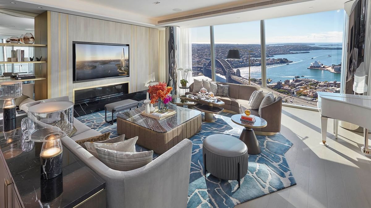 Harbour Villa living room with modern furniture overlooking a cityscape at Crown Hotels