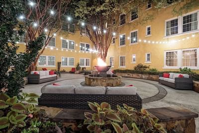 Strings of lights light up a courtyard at Artmore Hotel