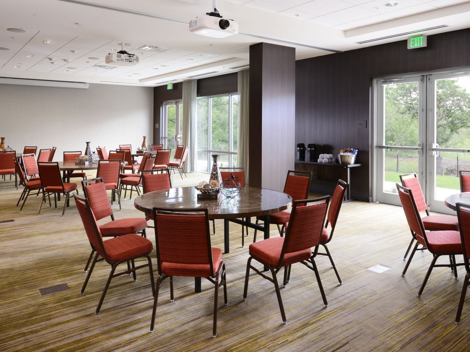 conference room with circular tables and red chairs