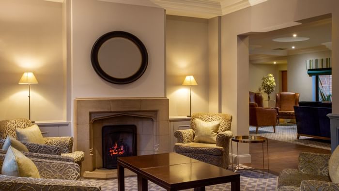 A lounge area with fireplace at Bridgewood Manor Hotel