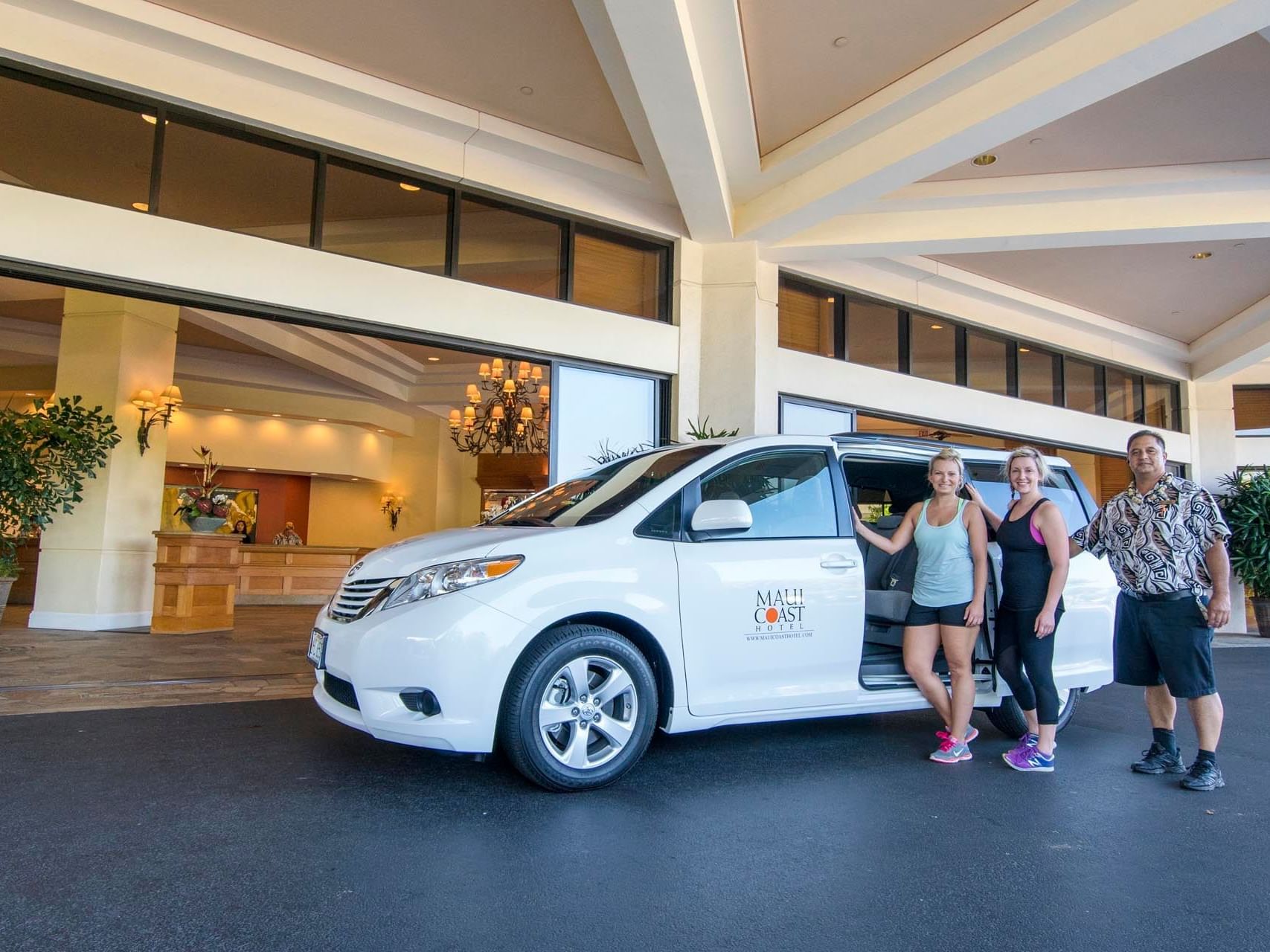 Shuttle with guests at the entrance of Maui Coast Hotel