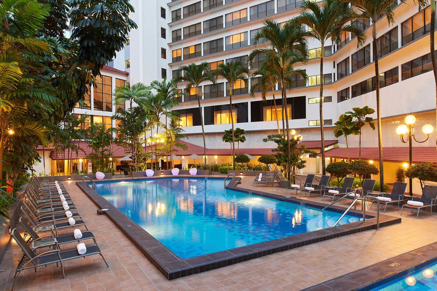 Image 40: Exterior view of York Hotel Singapore with outdoor pool & sun loungers