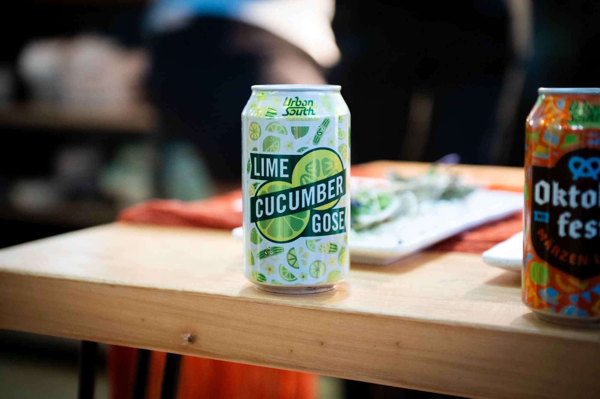 A brightly colored Lime Cucumber Gose beer can sitting on a bar top