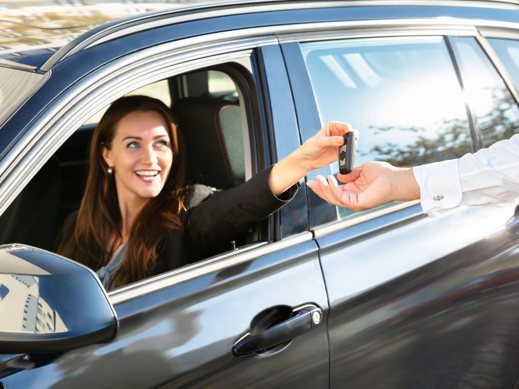 Lady with her car & giving car key to male hand at Austin Condo