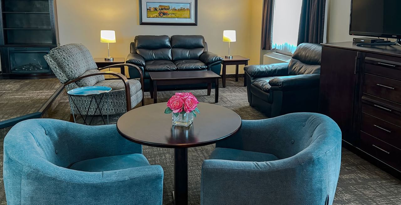 Lounge couches, tables, and TV in a hotel suite