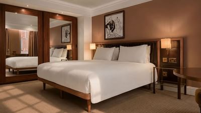 Elegant Collection Premium Room with white bedding and artwork at The May Fair Hotel, London, England