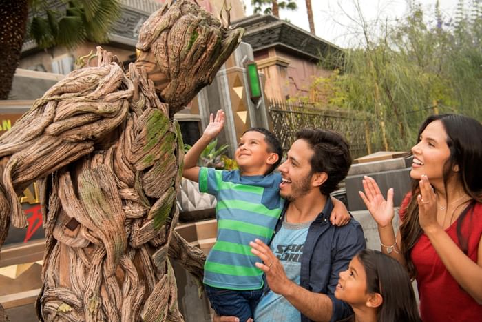 Family chatting with Groot in Disneyland near Anaheim Portofino Inn, a Disneyland area hotel with renovated family suites