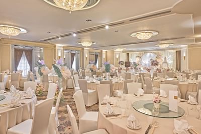 The elegantly set and spacious ballroom at Goodwood Park Hotel decorated for a wedding reception