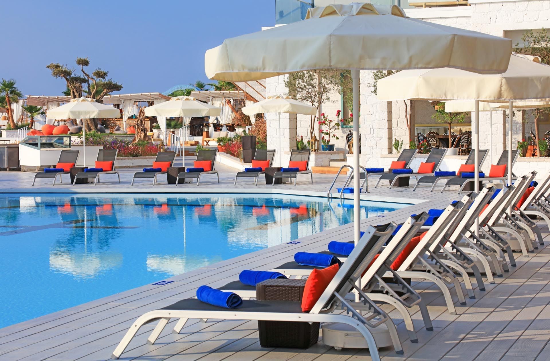 Pool area with pool chairs at Design Plus Seya Beach Hotel
