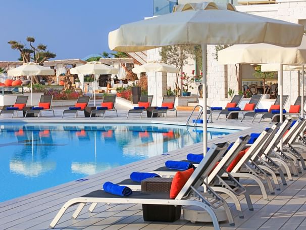 Pool area with pool chairs at Design Plus Seya Beach Hotel