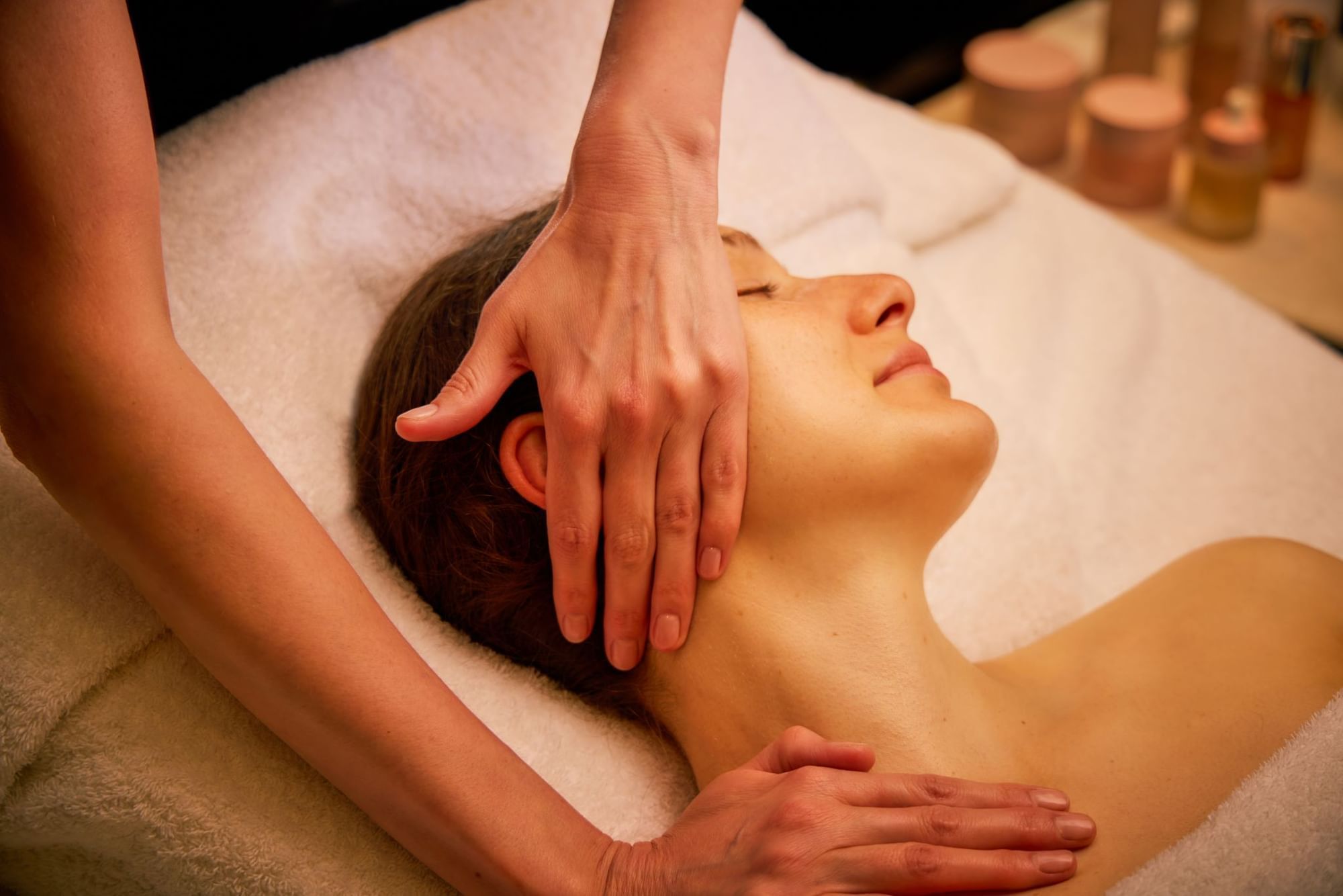 A luxurious facial treatment being performed on a serene client, a relaxing experience at The Londoner Hotel