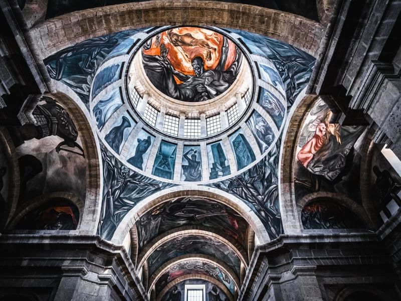 The ceiling of Hospicio Cabañas with paintings near One Hotels