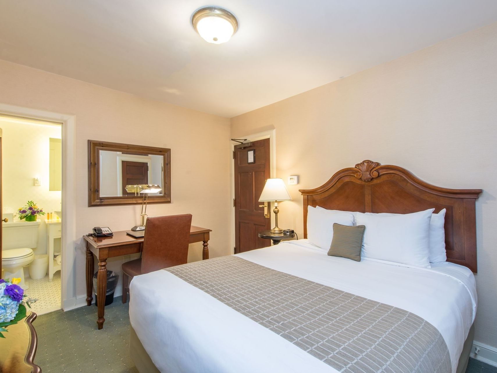 King bed & study table in European room at The Exeter Inn