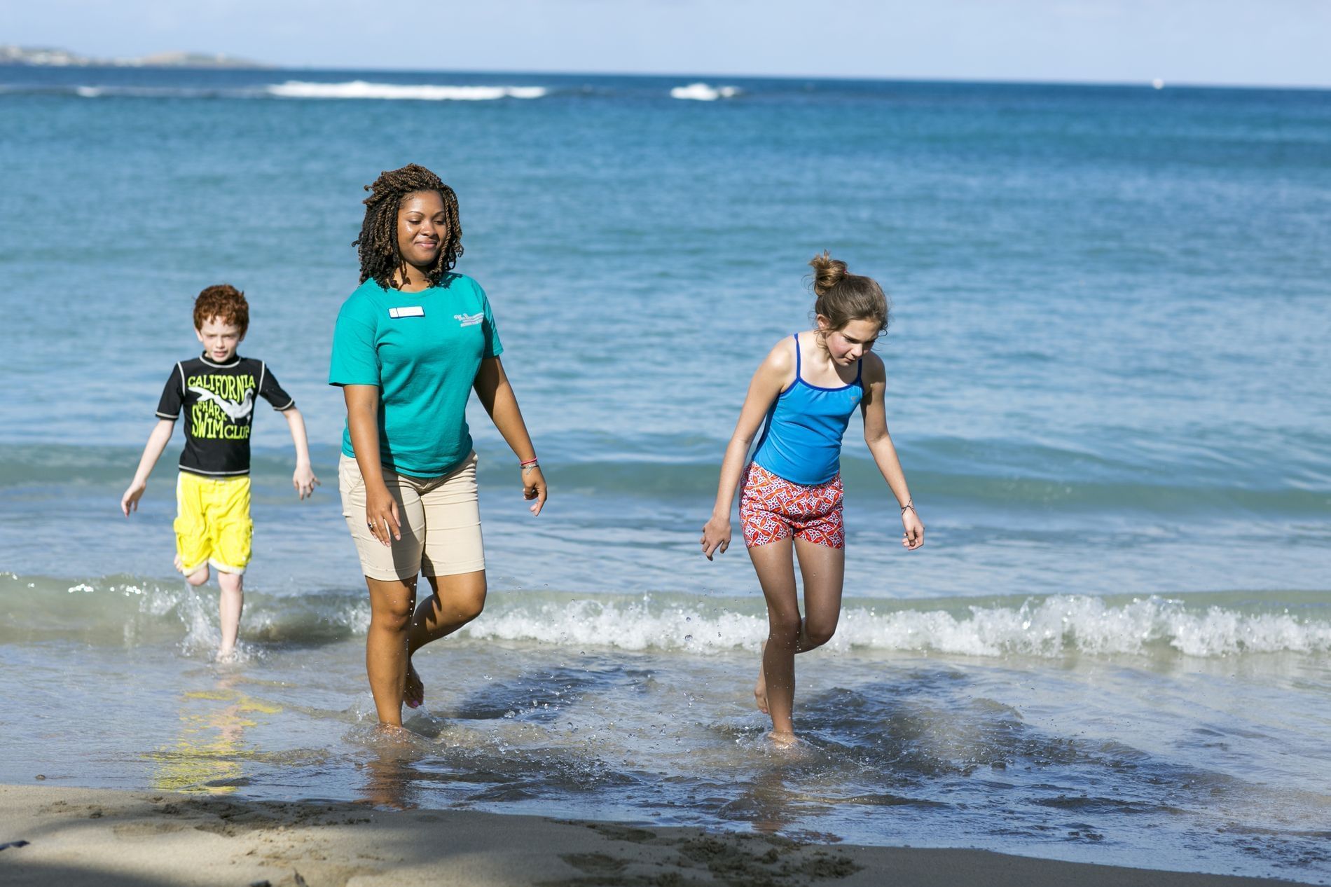 Kids walking on the beach near The Buccaneer Resort St. Croix