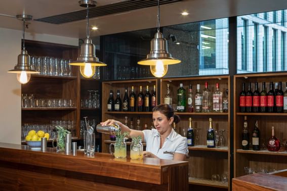 A bartender in Sage & Chilli Restaurant at St. Giles London