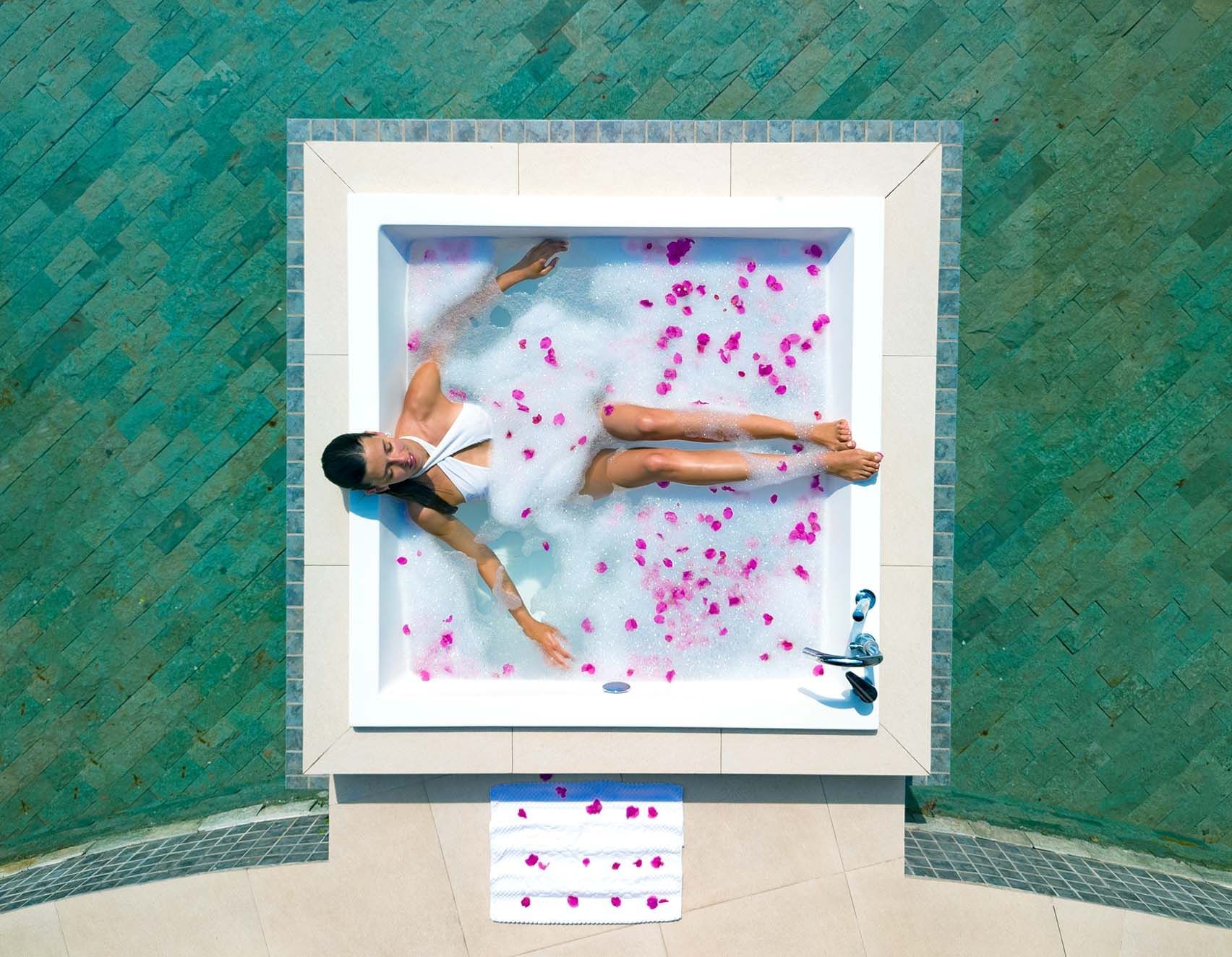 A lady relaxing in the spa pool at The Signature Collection