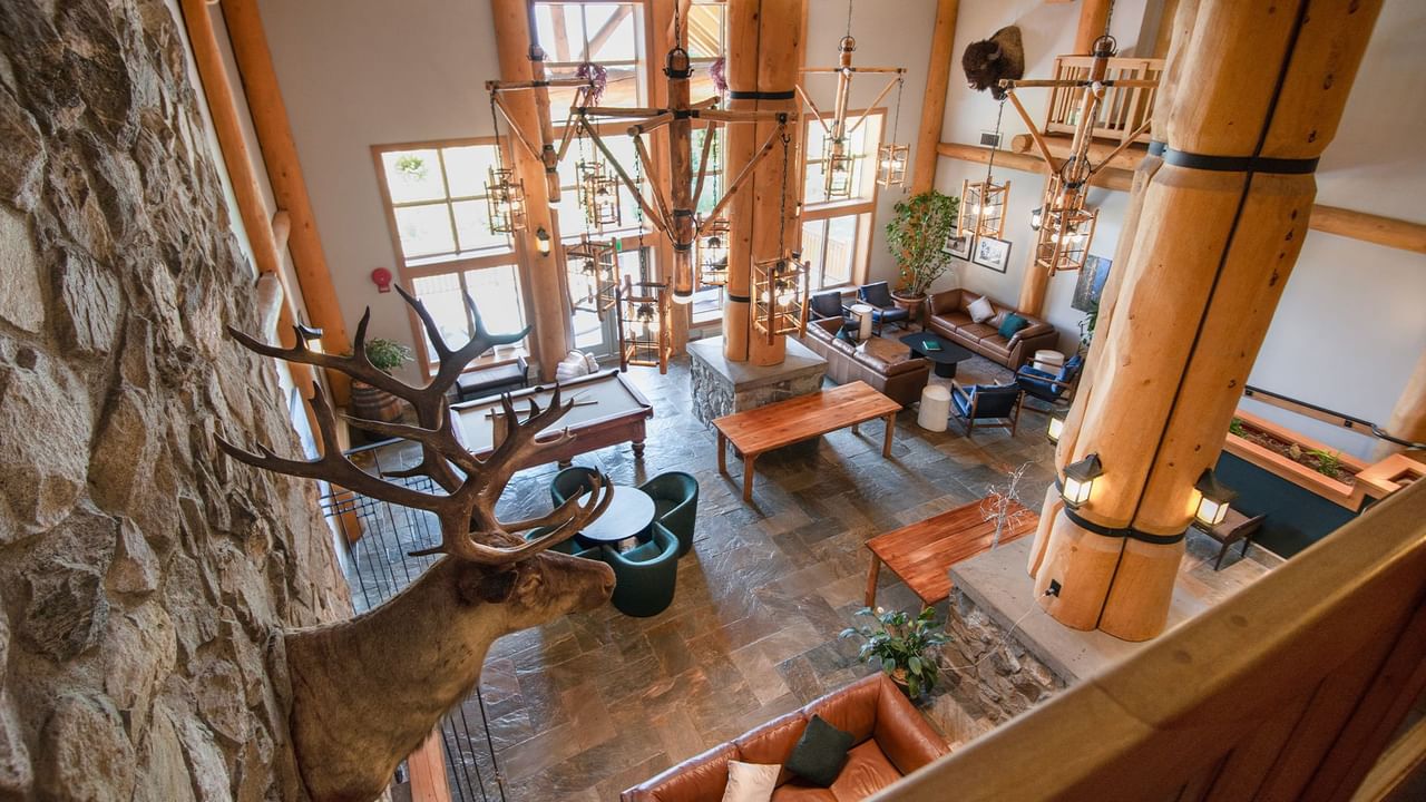 Lobby of Coast Hillcrest Hotel with couch, arm chair, and tables