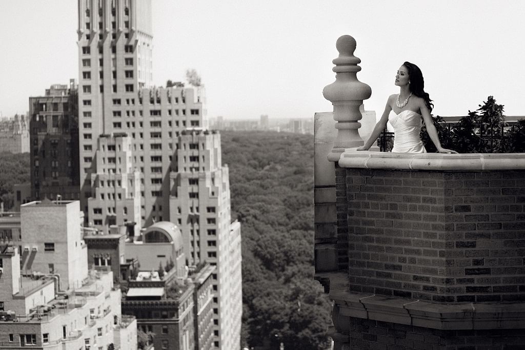 Black & white image of a bride on the terrace overlooking the city from Warwick New York