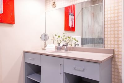 Bathroom vanity, large mirror & painting on the wall in King Premiere Studio at Retro Suites Hotel