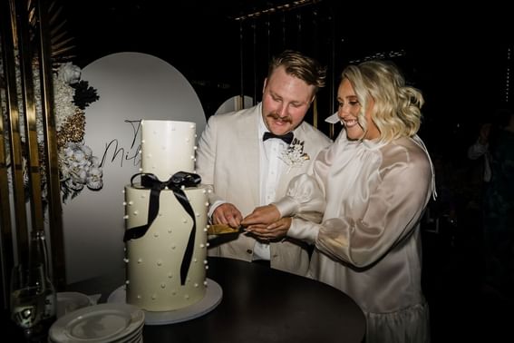 Wedding couple cutting the wedding cake at Melbourne Hotel Perth