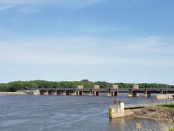 A massive bridge spanning a river in Lock & Dam 12 near Off Shore Resort