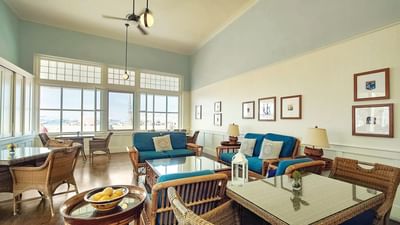 Cozy library room featuring wicker furniture at Pavilion Hotel in Avalon Catalina