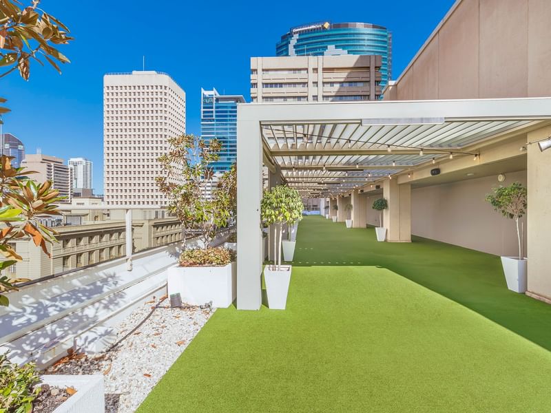 Rooftop garden with artificial grass and skyline view in Soiree Deck at Sofitel Brisbane Central