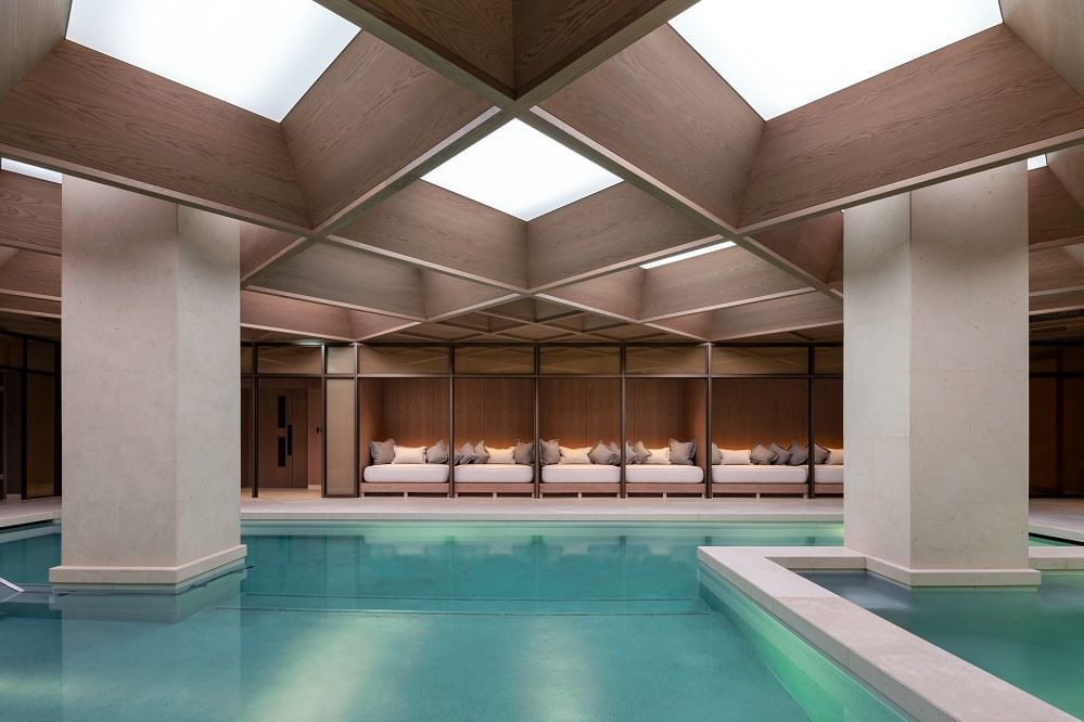 The Indoor pool with a lounge area at The Londoner Hotel