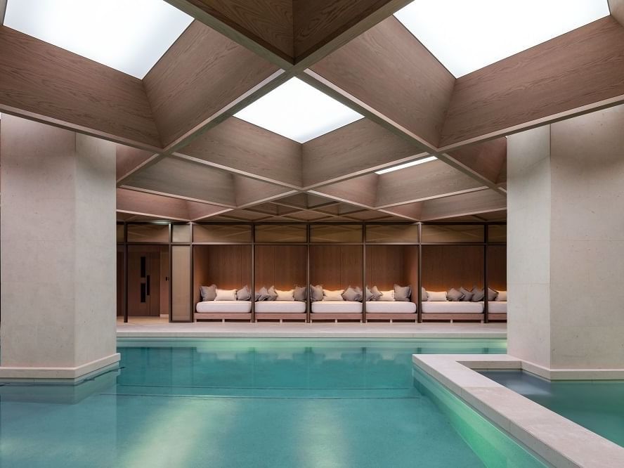 The Indoor pool with a lounge area at The Londoner Hotel