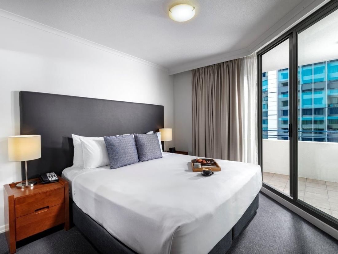 Two Bedroom Apartment with a cozy bed, direct access to a private balcony overlooking the city at The Sebel Brisbane