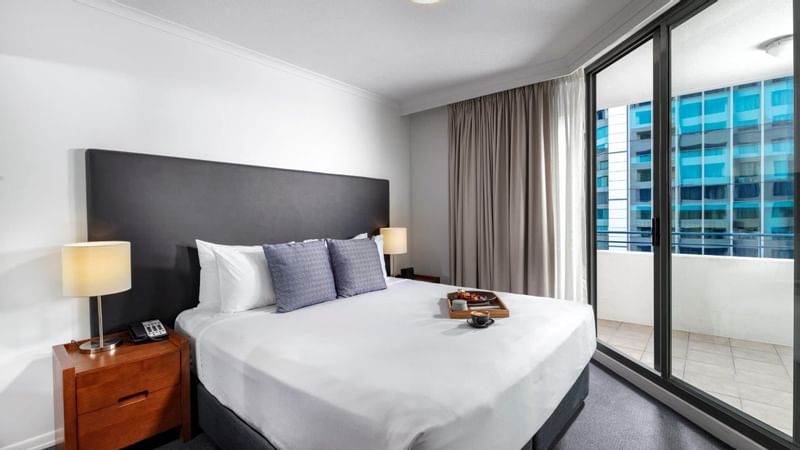 Two Bedroom Apartment with a cozy bed, direct access to a private balcony overlooking the city at The Sebel Brisbane
