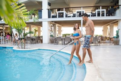 Couple walking towards the main pool at Sugar Bay Barbados