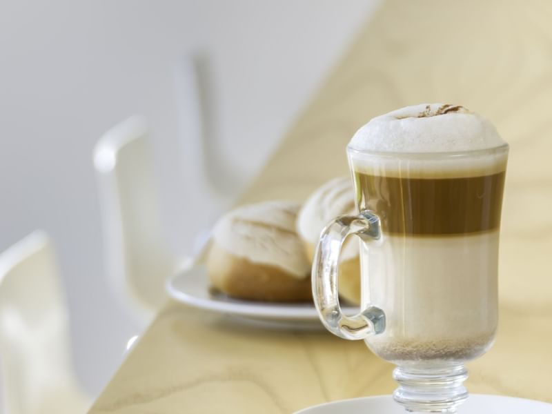 A glass of Latte macchiato served in a restaurant at Fiesta Inn