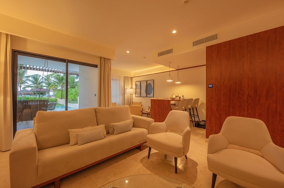 Modern living room with beige furniture at Live Aqua Resorts and Residence Club