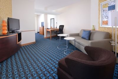 living room with sofa, accent chair and televison on media conso