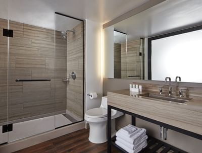 a toilet, shower, and sink in a bathroom