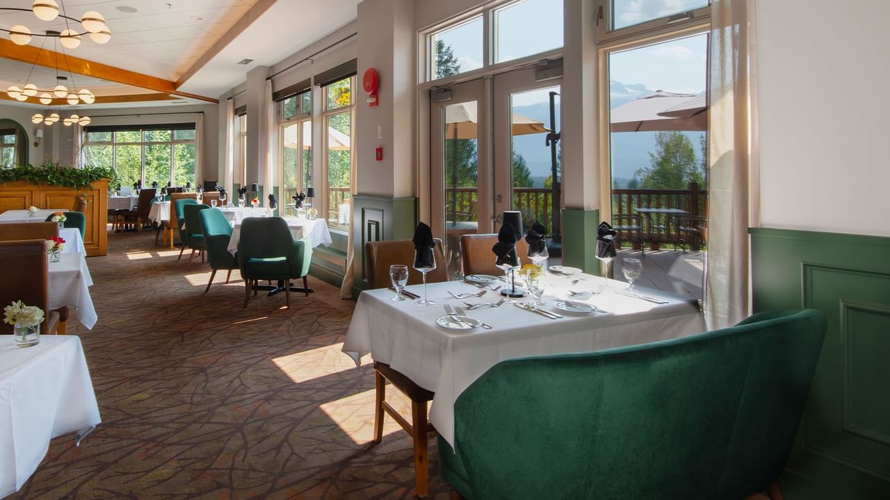 Hotel restaurant with dining table, chairs and patio