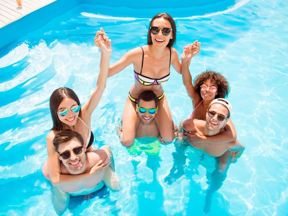 Couples enjoying in the outdoor pool at The Abidah Hotel