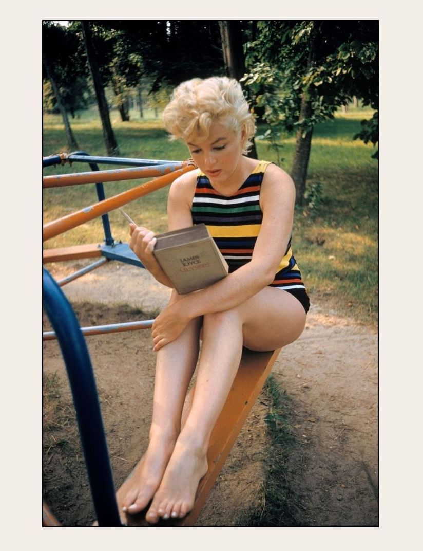 Marilyn Monroe artwork on display near The Londoner Hotel, showing her reading a book on a playground bench