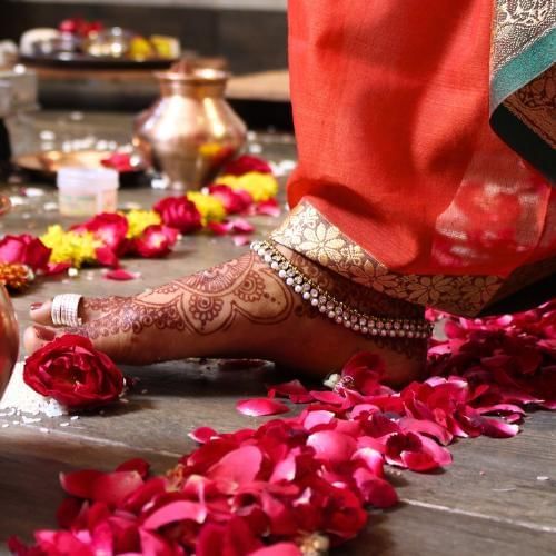 Bride taking saptapadi steps, a popular Indian wedding tradition