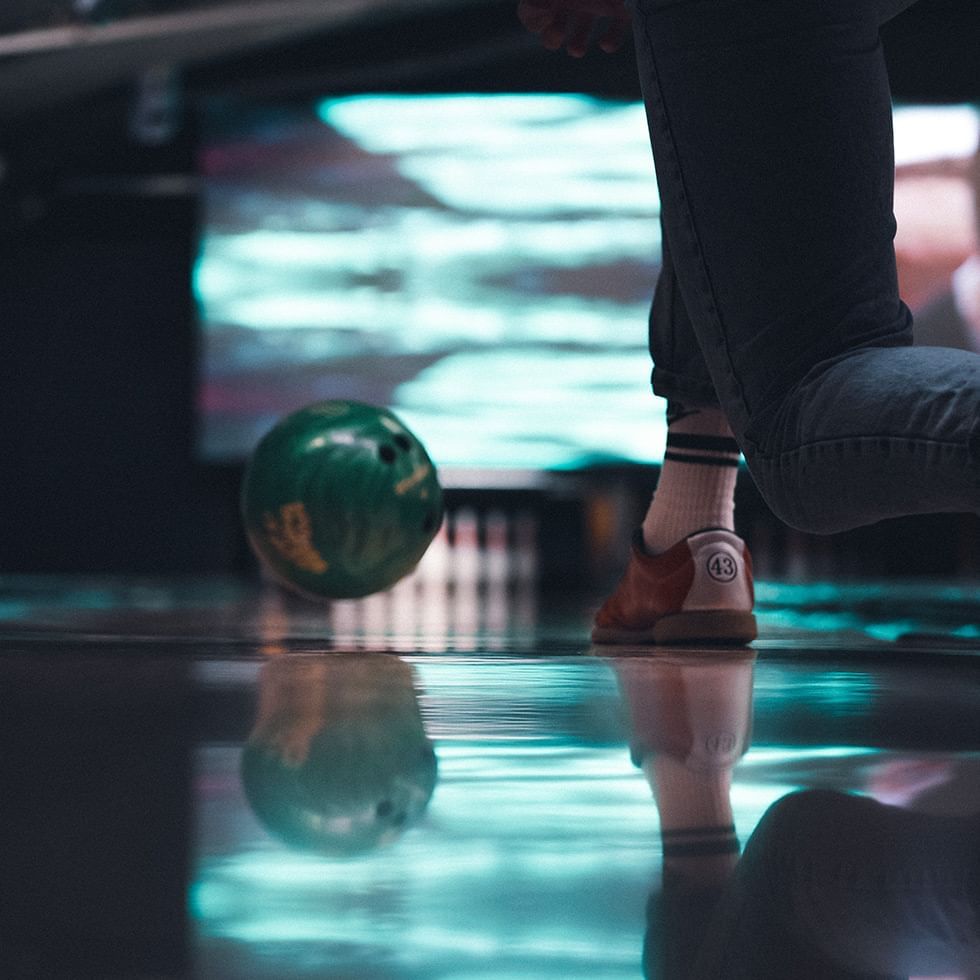 Person in bowling alley with ball rolling on lane at Falkensteiner Hotel Bratislava