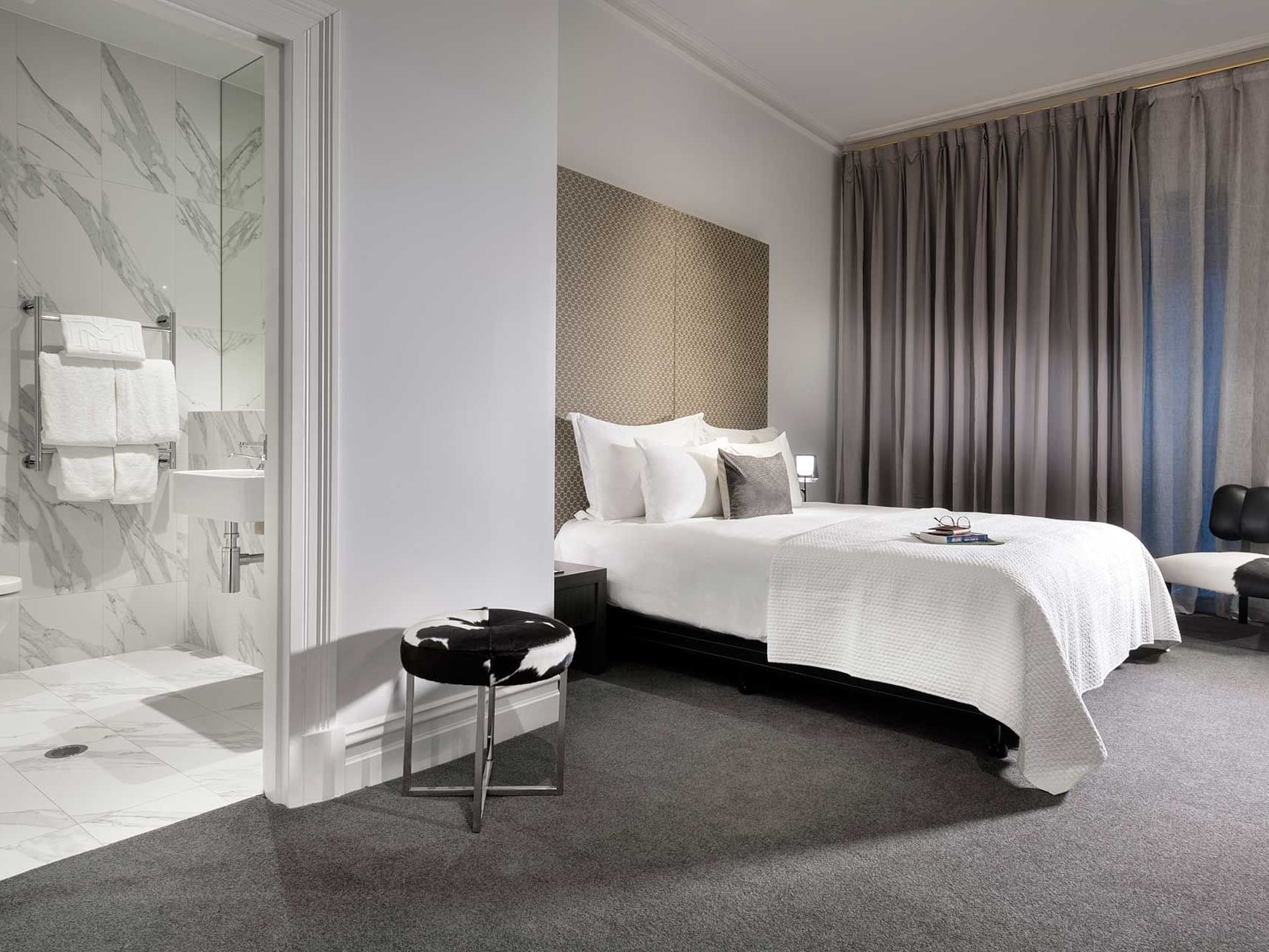 King bed by shower area in Heritage Conservatory with carpeted floors at Melbourne Hotel Perth