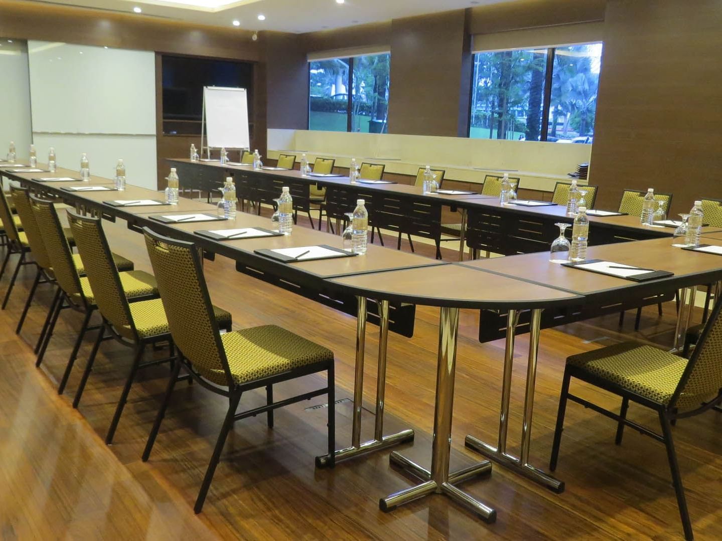 U-shaped table arrangement in Safir meeting room with wooden floors and projector screen at Saujana Hotel Kuala Lumpur