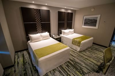 Two beds with a side table in Standard Room at Hotel Mirra, where to stay in San Luis Rio Colorado near Garita 